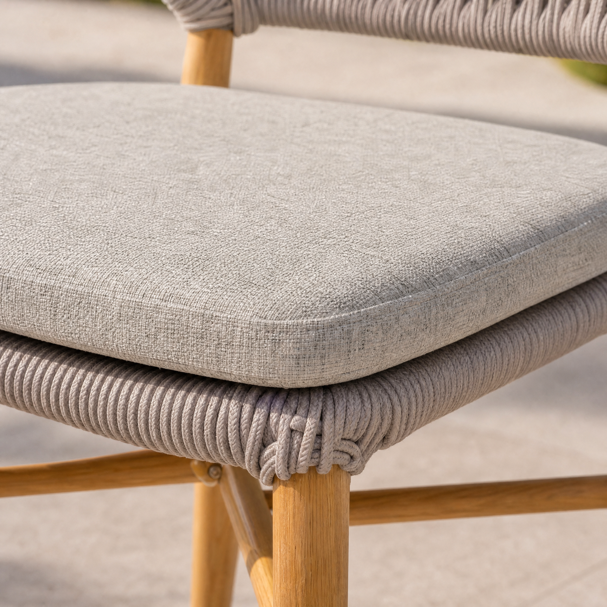 Generated with Kive.ai - Create a distinct close-up detail shot of the light gray seat cushion from Woven dining chair. Use Image 1 as the visual reference for the cushionâs exact shape_ fabric color_ fine wea.png